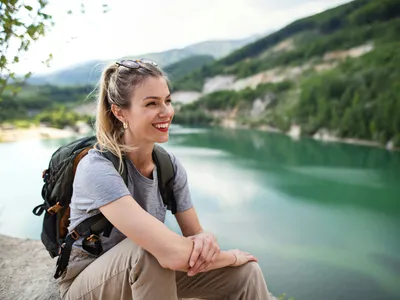 Hikers walking beside an alpine lake