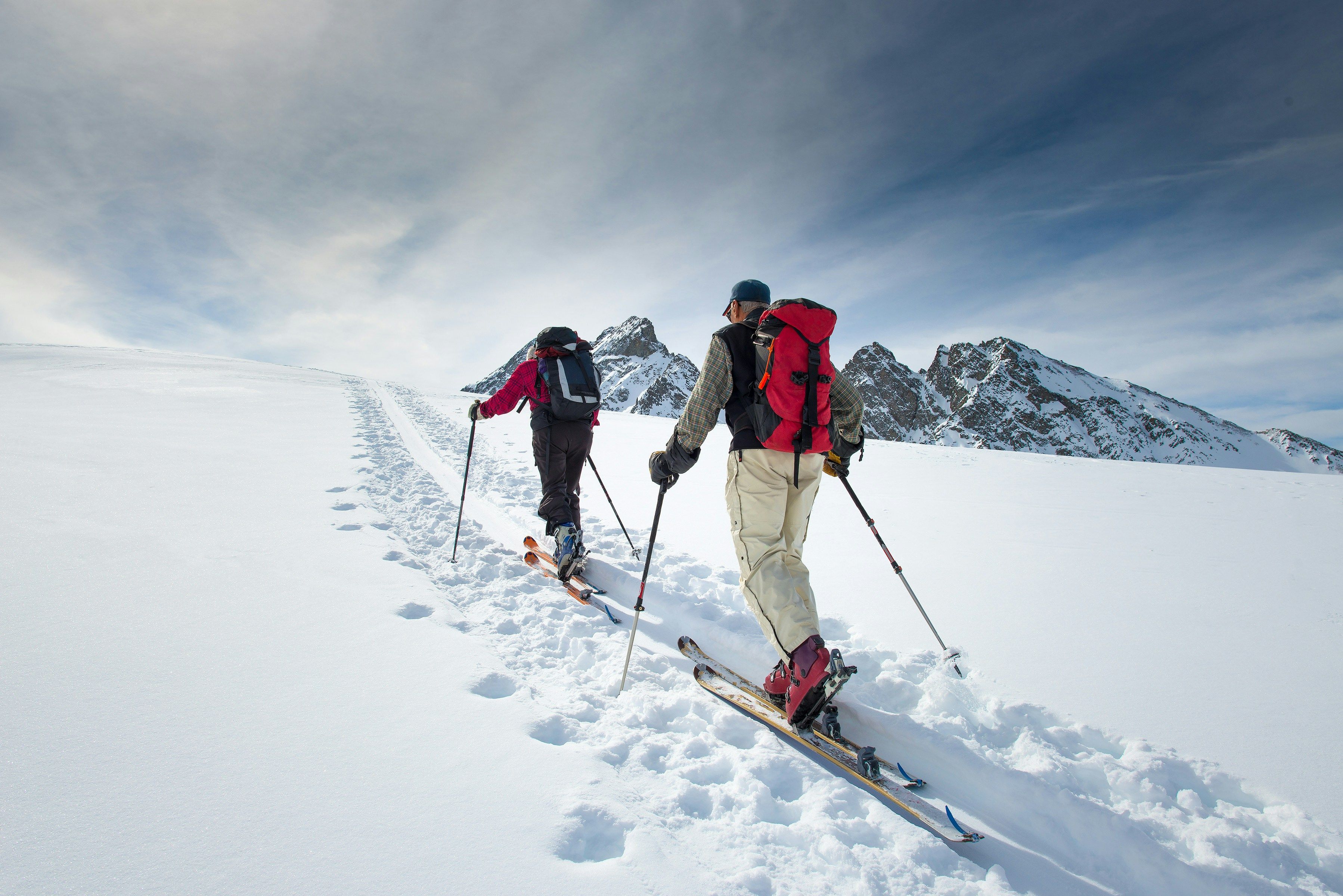 Mountain guide greeting guests at sunrise on a snowy ridge