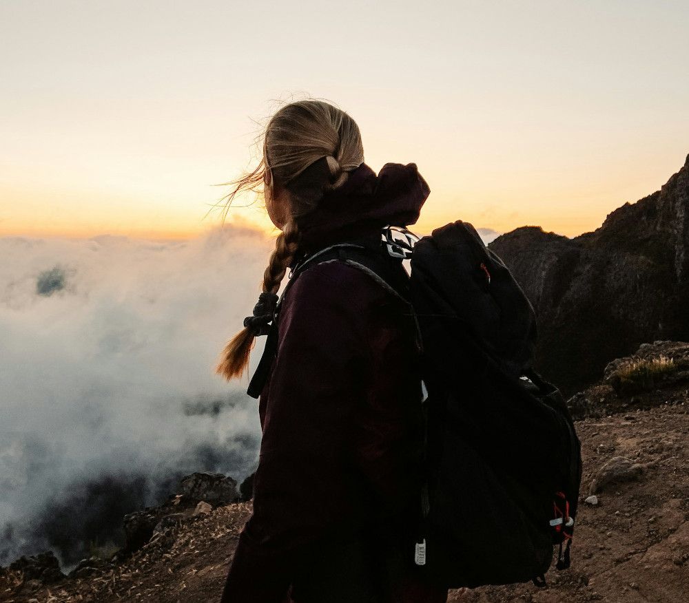 Group hiking at sunrise in the French Alps